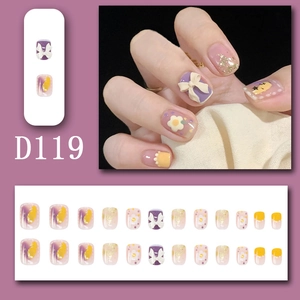 Detail of press-on nails D119 with purple floral patterns and cute bow accents