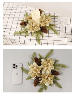 Detail of champagne gold poinsettia wreath with pine cones for festive table decor