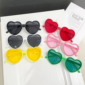 Flat lay of heart-shaped sunglasses in black white yellow red pink and green colors