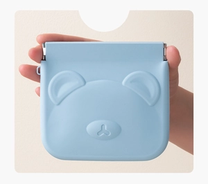 Blue silicone mini pouch with 3D bear design held in hand for digital accessories storage