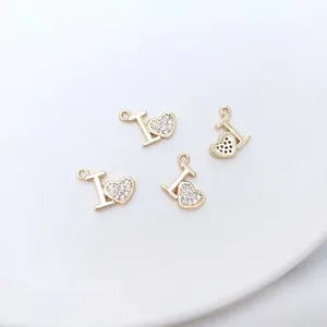 Close-up of 14K gold plated heart and letter I pendants with micro-pave cubic zirconia