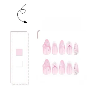 Close-up of pink gradient press-on nails with 3D roses, bows and pearl accents