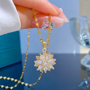Close-up of gold sunflower pendant with marquise-cut white zircon and twisted chain