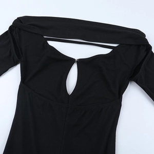 Close-up of black knitted off-shoulder dress featuring back cutout and metal hook closure