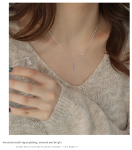 Detail view of the S925 sterling silver bar pendant necklace on a real model neck
