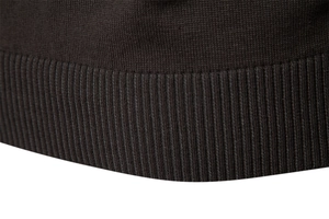 Detailed macro view of the premium fine-knit fabric and ribbed cuff texture on a men's cardigan