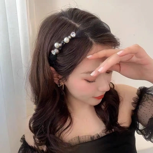 Detail view of fashion headband with black mesh, white pearls and sparkling rhinestones