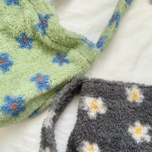 Close-up of soft faux lamb wool fabric texture featuring colorful floral patterns