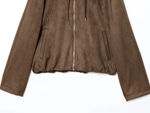 Detail of coffee brown suede jacket showing metal zipper and elastic ribbed hemline