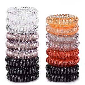Detail of stacked high-elasticity telephone cord hair ties in assorted solid colors