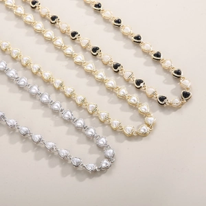 Detail of heart-shaped pendants with metal bead edges in gold and silver finishes