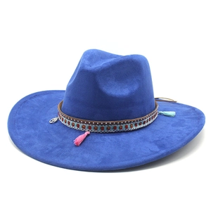 Close-up of bohemian blue suede fedora with ethnic woven band and colorful tassels