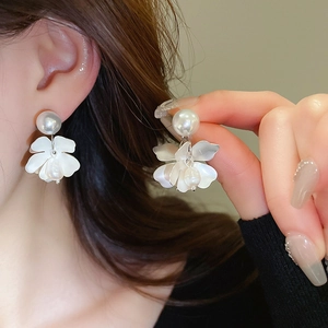 Detail of flower stud earring with shell petals and baroque freshwater pearl drop