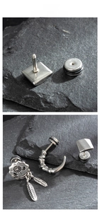 Details von Vintage-Edelstahlohrringen mit geometrischen und Federmotiven