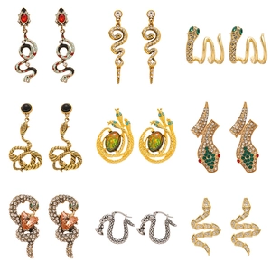 Nine pairs of vintage snake earrings featuring rhinestones and enamel in a golden finish