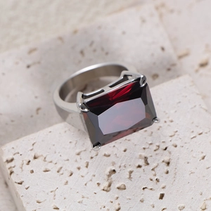 Macro view of rectangular red gemstone ring on natural stone setting for elegant detail