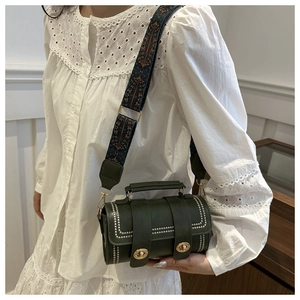 Detail of dark green Boston bag featuring pearl studs and a retro jacquard wide strap