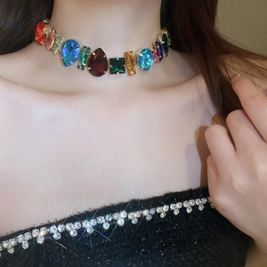Close-up of multicolor rhinestone necklace with teardrop and square crystals on neck