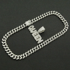 Detail of silver Cuban chain necklace with iced-out QUEEN pendant and secure clasp closure
