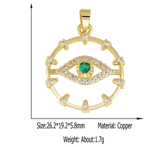 Detail view of a gold evil eye pendant with green zircon and size dimensions