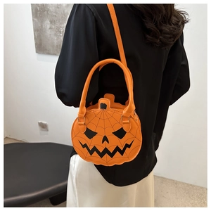 Detail of orange pumpkin shaped PU leather crossbody bag with spooky face and cobweb design