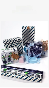 Detailed view of assorted high-end holiday gift wrapping paper with rolls