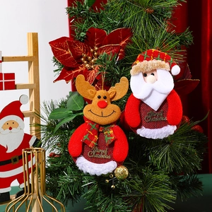 Detail of plush Santa and Reindeer ornaments with Merry Christmas text on a Xmas tree