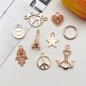 Close-up of golden vintage-style charms including anchors and stars for DIY jewelry