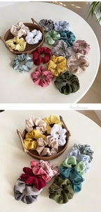 Detailed view of assorted satin hair scrunchies in multiple colors and silky fabric