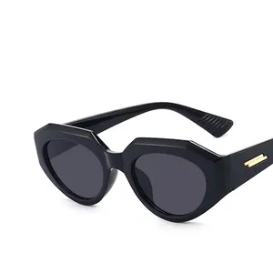 Chic black geometric irregular sunglasses with dark lenses and gold metal accents