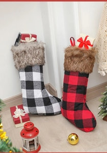 Close-up of black and red buffalo plaid Christmas stockings with faux fur trim