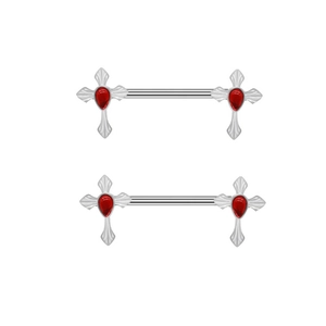 Macro shot of silver cross nipple rings with red teardrop stones on white background