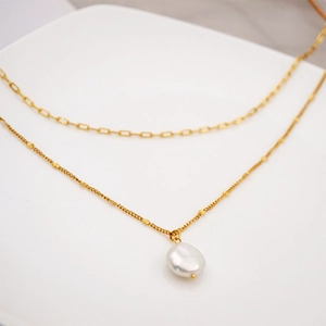 Double layered gold necklace with baroque pearl pendant and vintage layered chain style