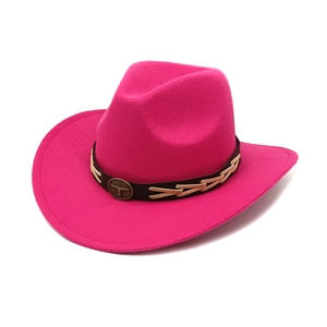 Rose red felt cowboy hat with braided leather band and retro metal emblem on white background