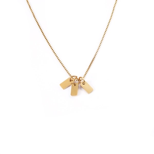 Detailed view of three polished gold square pendants on a delicate stainless steel box chain