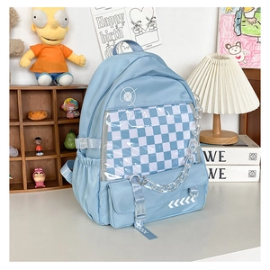 Detail view of light blue backpack with transparent PVC pocket and acrylic chain decoration