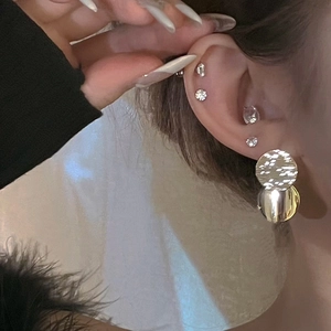 Silver needle sequin tassel earrings and sparkling stud set shown on model ear
