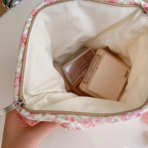 Detailed interior view of pink floral quilted makeup bag with soft cotton lining