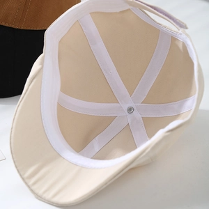 Macro shot of children beige beret hat internal sweatband and reinforced stitching detail