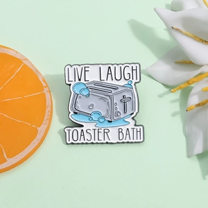 Funny toaster bath enamel pin with Live Laugh Toaster Bath text on green background