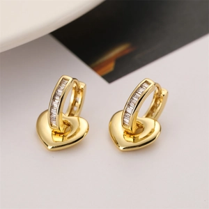 Detail view of gold-plated heart earrings featuring rectangular zircon stone settings