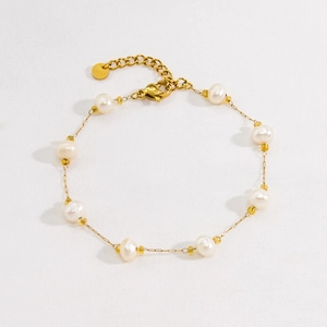 Minimalist gold chain pearl bracelet featuring white freshwater pearls and yellow faceted beads