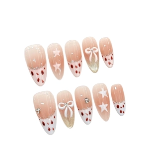 Pink cat-eye press-on nails with 3D bows, stars, and rhinestones on white background