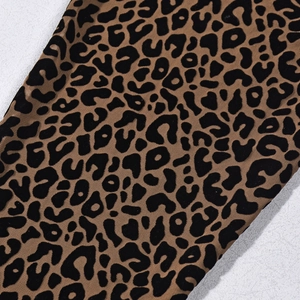 Close-up of leopard print mesh fabric with detailed flocking texture and brown pattern