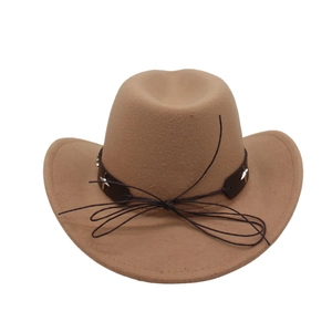 Detail of camel felt fedora hat featuring brown leather band and silver star rivets