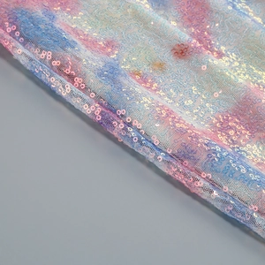 Detail of sequin fabric with iridescent pink blue and purple gradients on mesh mesh fabric