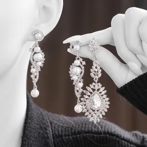 Elegant silver tassel earrings with crystals and pearls in a luxurious leaf-like design