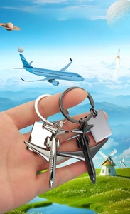 Macro shot of 3D airplane model keychains in silver and gun black zinc alloy finish