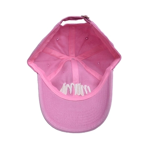 Detail view of pink cotton baseball cap interior showing six-panel stitch and metal buckle