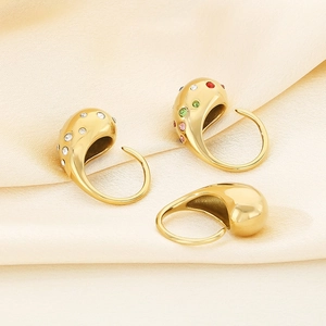 Polished gold stainless steel teardrop rings with colorful gemstones on silk